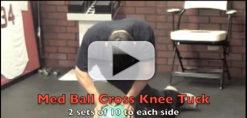med ball cross knee tuck exercise