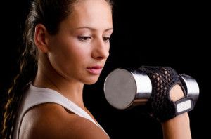 Beautiful woman exercising with dumbbells