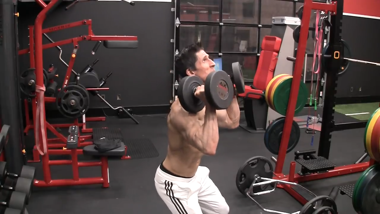 stick out your rear and perform a hip hinge in the dumbbell push press shoulder exercise